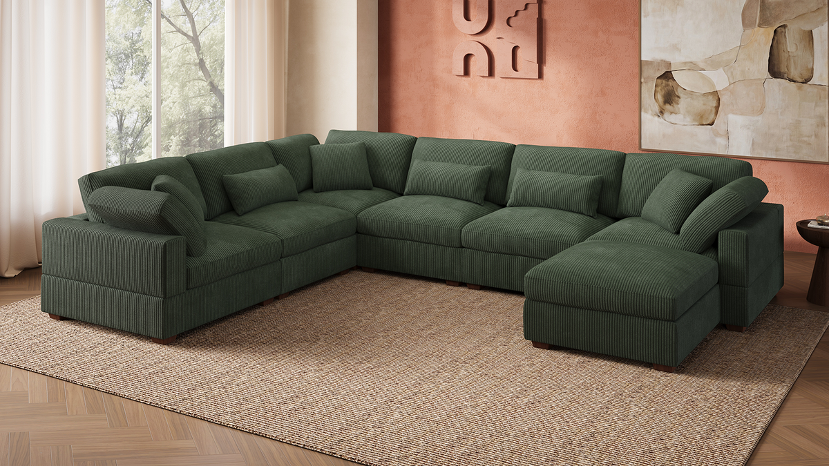 Green corduroy modular sleeper sectional with chaise and storage in a small apartment living room