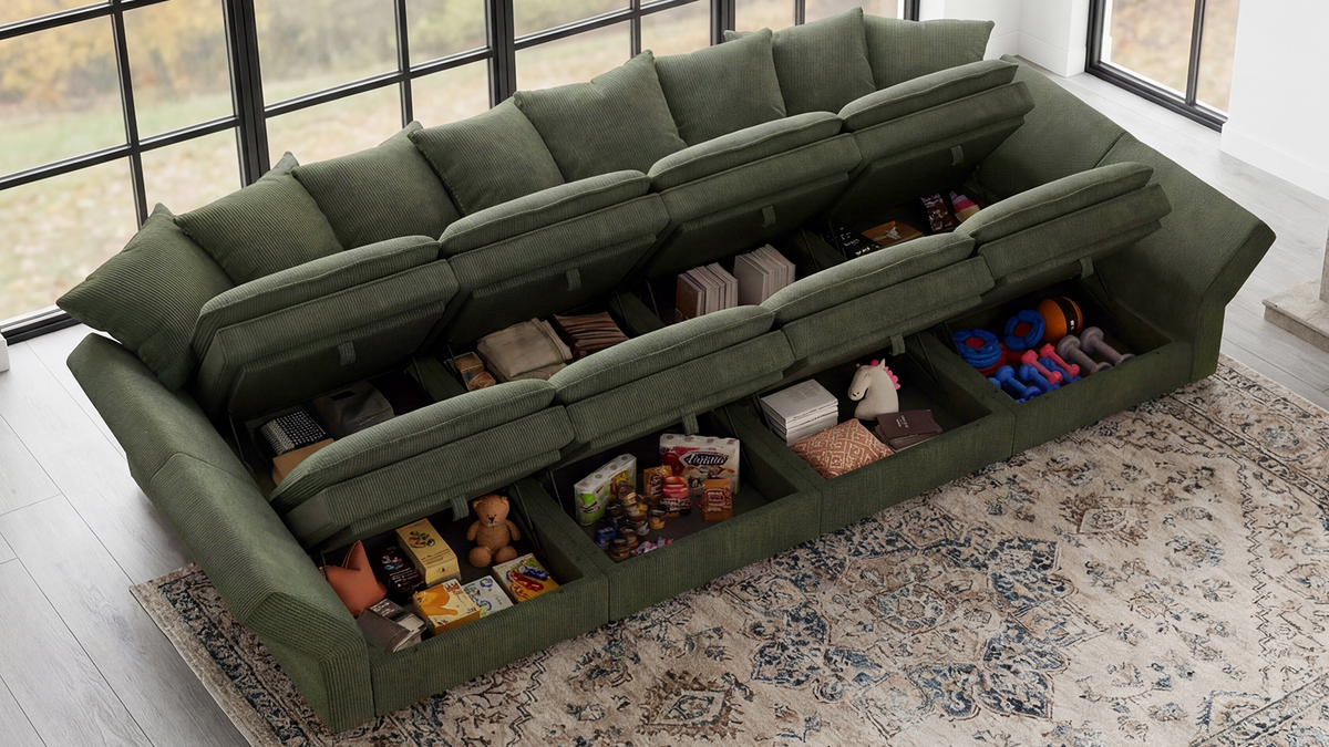 Green sectional sofa with hidden under-seat storage compartments holding snacks, books, and toys in a bright living room