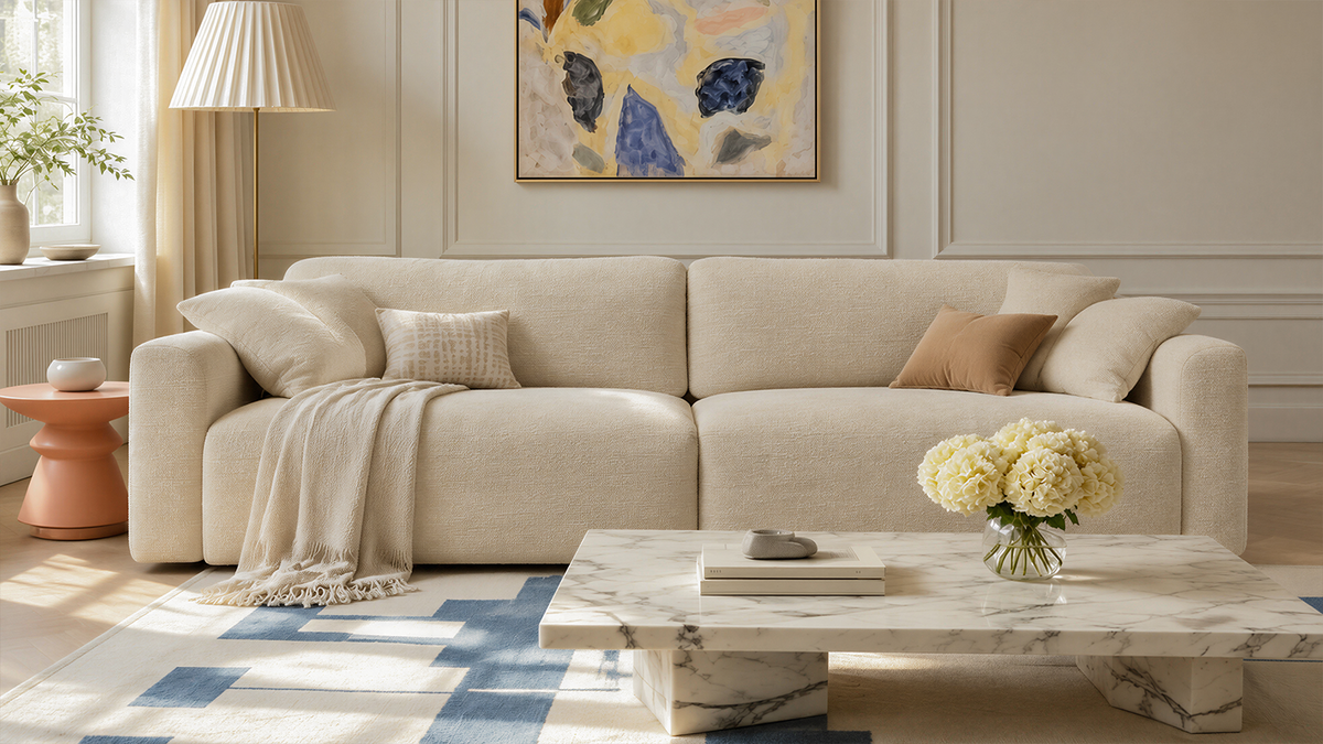 Cala ivory chenille sleeper sectional shown as everyday seating in a cream bouclé living-room with neutral throw pillows