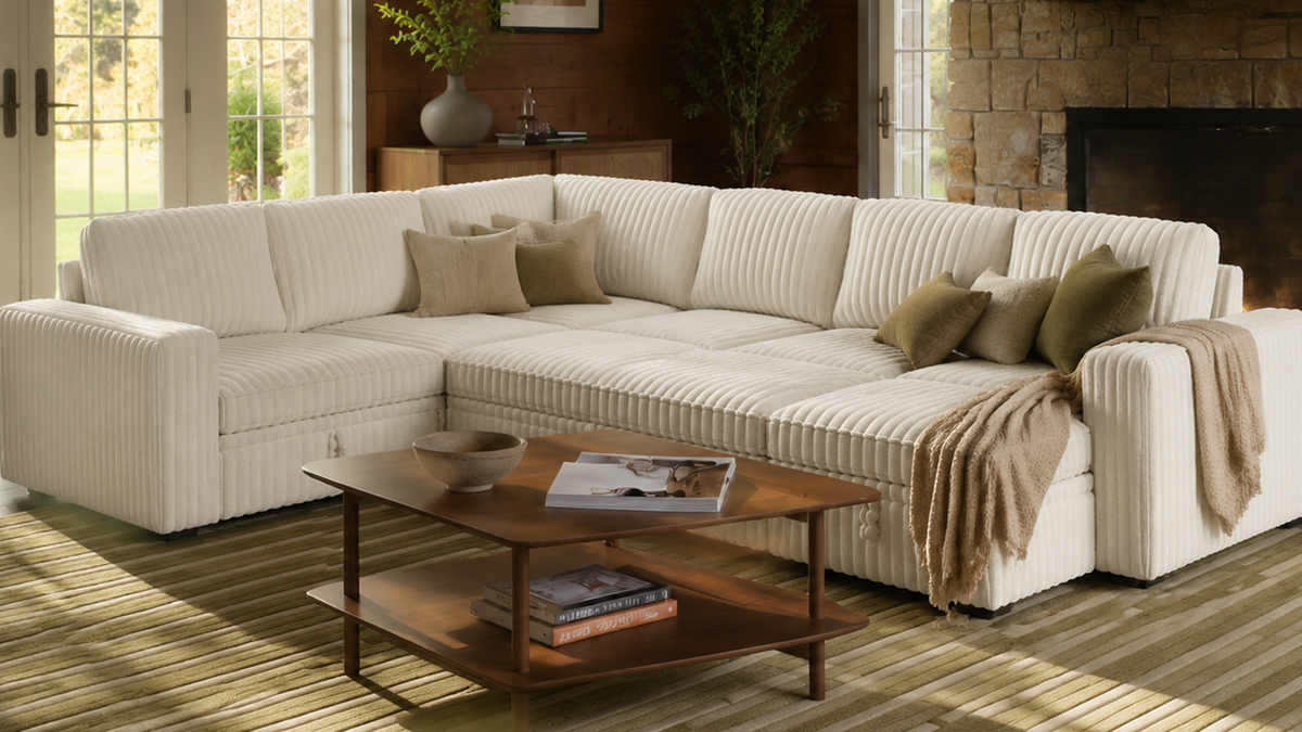 Cream L-shaped modular sectional sofa with ribbed upholstery in a modern living room